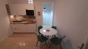 a kitchen with a table and chairs in a room at Palazzetto di Neubourg in Naples