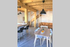 a kitchen and dining room with a table and chairs at House Zemina in Lumbarda