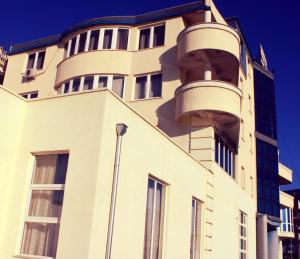 a building with balconies on the side of it at Hotel Apollonia in Prishtinë