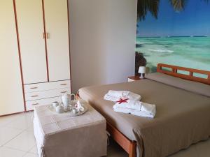 a bedroom with two beds and a view of the ocean at Casa Laura in Acciaroli