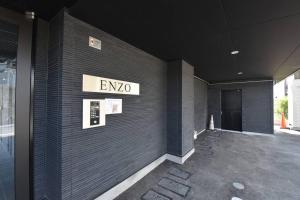 a building with a sign on the side of it at Enzo Fukuoka in Fukuoka