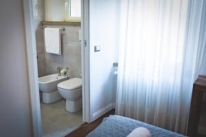 a bathroom with a toilet and a sink at Piazza Duomo Deluxe in Cecina