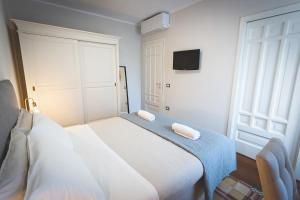 a bedroom with a bed with two towels on it at Piazza Duomo Deluxe in Cecina