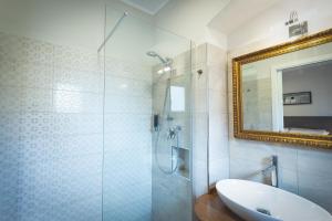 a bathroom with a shower and a sink and a mirror at Piazza Duomo Deluxe in Cecina