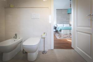 a bathroom with a toilet and a sink at Piazza Duomo Deluxe in Cecina