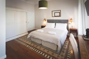 a bedroom with a large bed with two pillows on it at Piazza Duomo Deluxe in Cecina
