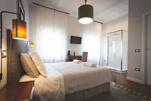 a bedroom with a large white bed in a room at Piazza Duomo Deluxe in Cecina