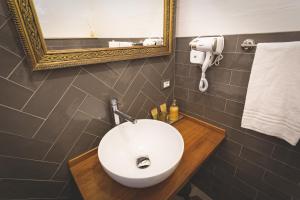a bathroom with a white sink and a mirror at Piazza Duomo Deluxe in Cecina