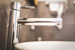 a close up of a faucet of a sink at Piazza Duomo Deluxe in Cecina