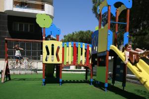two young children playing on a playground at Hotel Blaumar in Blanes