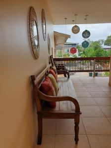 a bench in a room with mirrors on the wall at Amalia Apartments in Paramaribo