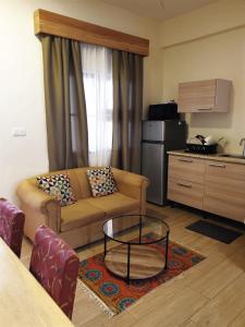 a living room with a couch and a kitchen at Amalia Apartments in Paramaribo