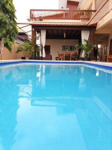 a large blue swimming pool in a hotel at Amalia Apartments in Paramaribo