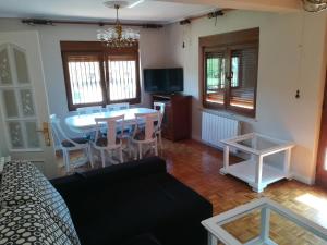 Casa Con Jardin في Pomaluengo: غرفة معيشة مع أريكة وطاولة