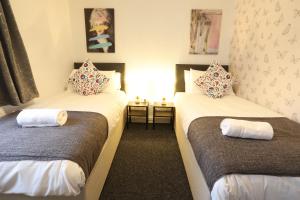 a room with two beds with pillows on them at B'ham NEC/Airport/HS2 Short Stay in Birmingham