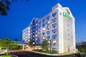 a hotel building with a lit up sign on it at Holiday Inn Express Hauppauge-Long Island, an IHG Hotel in Hauppauge