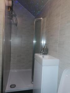 a bathroom with a shower and a sink at Heavenly Nights Guest House in Sheffield