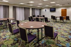 a conference room with tables and chairs and a tv at Holiday Inn Franklin - Cool Springs by IHG in Franklin +38 photos