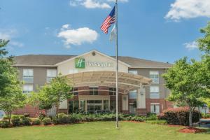 an exterior view of a hotel with an american flag at Holiday Inn Atlanta/Roswell, an IHG Hotel in Roswell