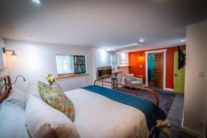 a bedroom with a large bed and a living room at Gallery Suite art-cation vacation! in Nelson