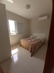 a bedroom with a bed and a window at Pousada Gomes in Florianópolis