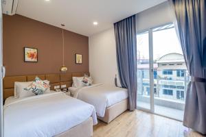 Postel nebo postele na pokoji v ubytování Helen Fin Inn & Apartment