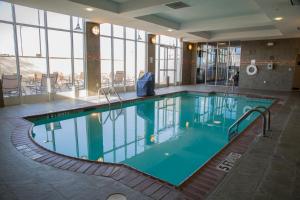 a large swimming pool in a hotel lobby at Holiday Inn Pearl - Jackson Area, an IHG Hotel in Pearl