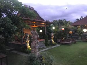 a garden with a gazebo with a statue in the yard at Bali Eco Living Yoga Healing Meditation and Retreat Center in Denpasar +124 photos
