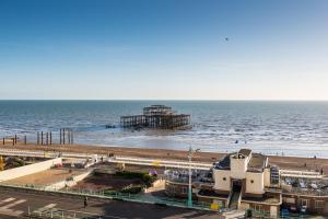 a view of a beach with a pier and the ocean at Holiday Inn Brighton Seafront by IHG in Brighton & Hove