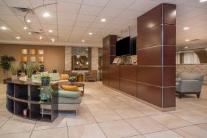 a lobby with a dining area and a living room at Holiday Inn Bloomington-University Area, an IHG Hotel in Bloomington
