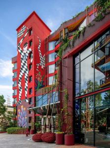 a red building with a mural on the side of it at MeStyle Museum Hotel in Bangkok
