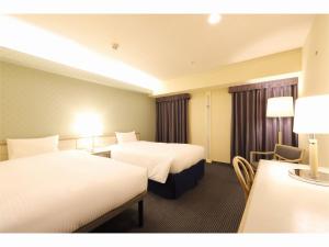 Postel nebo postele na pokoji v ubytování Shin-Yokohama Kokusai Hotel