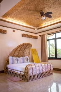 a wicker bed in a room with a ceiling at Peak View Resort in San Vicente