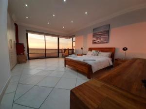 a bedroom with a bed and a view of the ocean at SeafrontC in Swakopmund