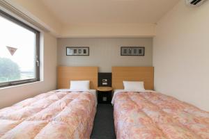 Hotel Econo Taki 객실 침대