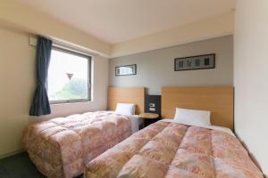 Hotel Econo Taki 객실 침대