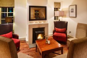 a living room filled with furniture and a fire place at Holiday Inn Dumfries, an IHG Hotel in Dumfries