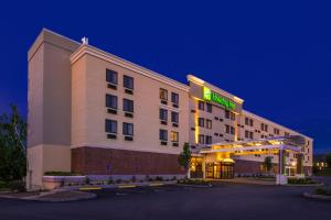 a hotel with a lit up sign in a parking lot at Holiday Inn Concord Downtown, an IHG Hotel in Concord