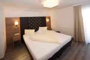 Ein Bett oder Betten in einem Zimmer der Unterkunft Hotel Tristkogel