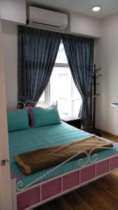 a bedroom with a large bed with a window at D'Perdana Residence in Kota Bharu