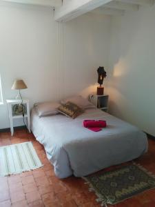 Un dormitorio con una cama con una bata roja. en Les Campanules - Neuvy en Sullias, en Neuvy-en-Sullias
