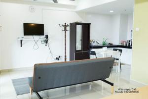 a living room with a couch and a tv at D'Perdana Residence in Kota Bharu