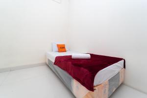 Кровать или кровати в номере KoolKost @ Harapan Indah