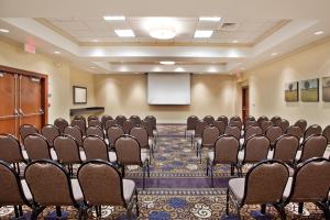 a conference room with rows of chairs and a screen at Holiday Inn Atlanta-Gas South Arena Area by IHG in Duluth +33 photos
