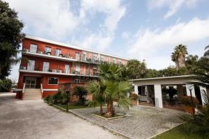 a building with a palm tree in front of it at Hotel Giardino d'Europa in Rome