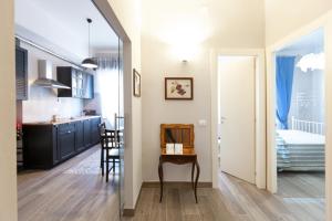 a kitchen and a dining room with a table in a room at Cinque Terre Mon Amour in La Spezia