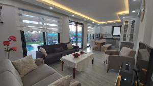 uma sala de estar com sofás e uma mesa em Private Villa in Gocek Villa Perest em Göcek