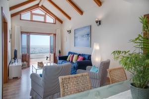 a living room with a couch and chairs at Casa Jimena in Punta Mujeres