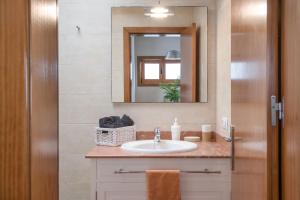 a bathroom with a sink and a mirror at Casa Jimena in Punta de Mujeres +17 photos