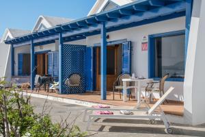a patio with a table and chairs on a house at Casa Jimena in Punta de Mujeres